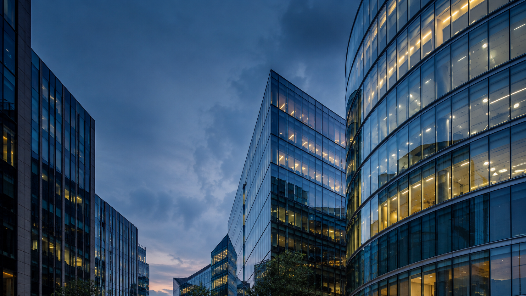 Illustrative modern glass office buildings at dusk